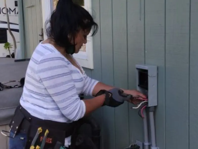Licensed electrician wiring an exterior subpanel in Niceville